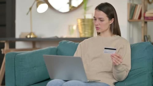 Online Shopping Failure on Laptop By Young Woman on Sofa