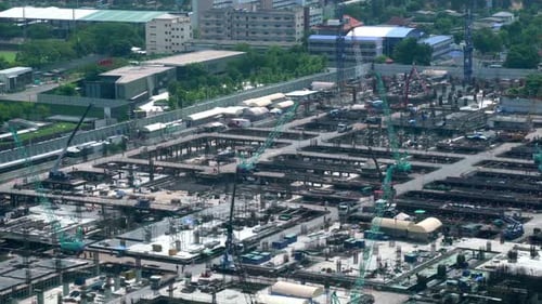 Large construction site with heavy construction machinery in metropolis