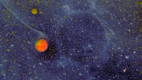 Rounded Red Yellow Particles on a Bluewhite Background with Sequins