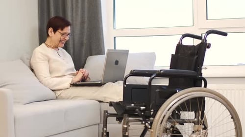 Handicapped Woman with Lapot Lay on Couch