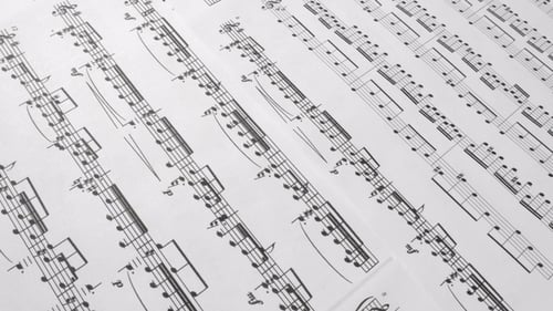 Sheet Music Background with Black Notes