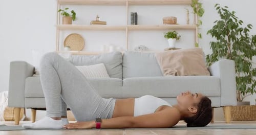 Young African American Woman Practicing Gluteal Bridge Exercise, Making Buttocks Workout at Home