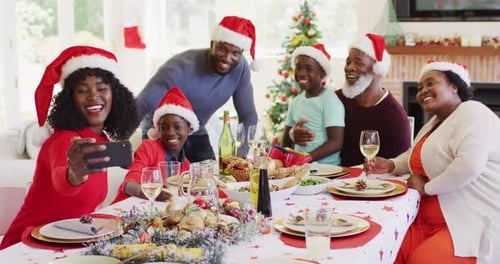 Family Christmas Celebration with Santa Hats and Dinner