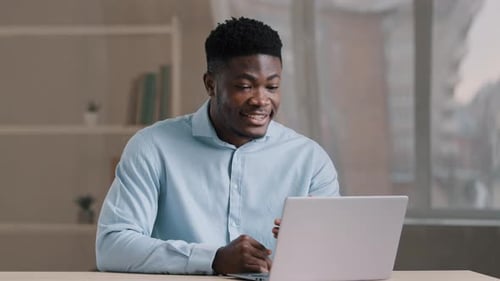 Young Adult Man Video Conferencing at Home