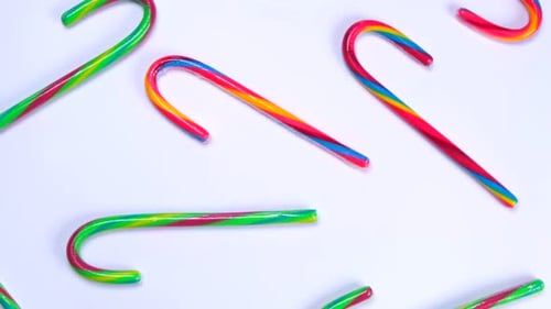 Rotating White Background with Multicolored Candy Canes New Year Holidays and Christmas Concept