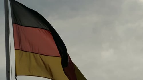 German Flag Waving Against Cloudy Sky