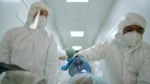 Medical Team Rushes Patient Down Hospital Hallway