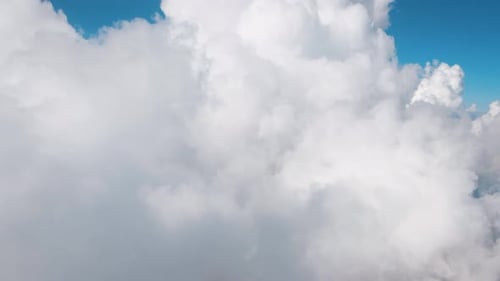 Aerial View of Fluffy Clouds and Blue Sky