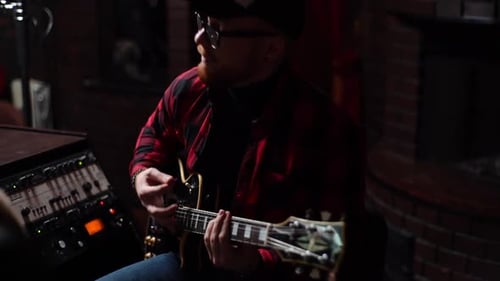 Stylish Musician in Cap and Glasses Enjoying Performing Favorite Music Playing on Electric Guitar