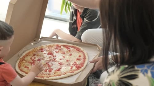 Family Opens Pizza Box Together
