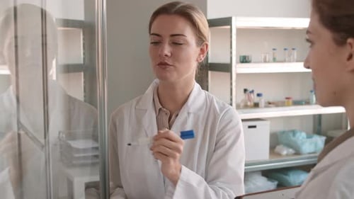 Female Scientists Discussing Research in Laboratory Setting