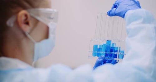 Laboratory Work With Test Tubes and Blue Liquid