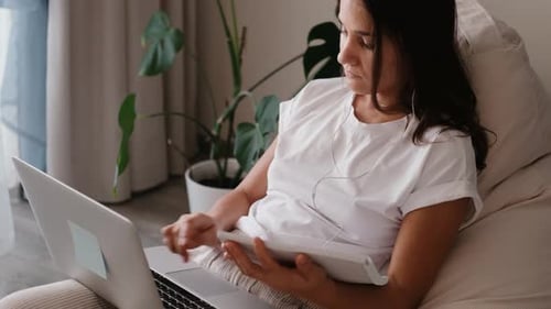 Woman Working from Home with Laptop and Tablet