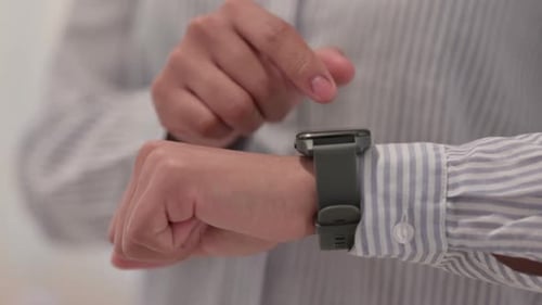 Close Up of Hands of African Woman Using Smart Watch