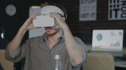 Game Designer Wearing VR Headset and Working in Augmented Reality in Office