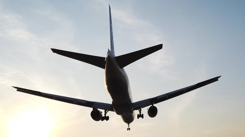 Airplane Flying Overhead at Sunset in the Sky