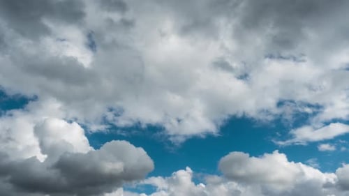 Clouds Billowing across Vibrant Blue Sky Time Lapse