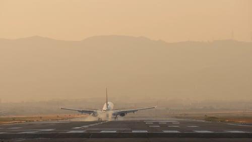 Airplane Landing on Runway During Golden Hour