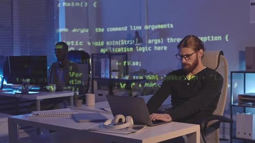 Programmers Working in Dark Office