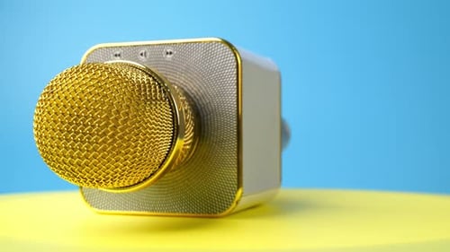 Golden mic rotate on surface.