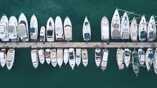 Fly over yachts moored at the pier.