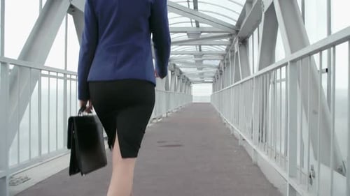 Businesswoman Walks on Overpass to Work