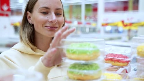 Woman Selects Tasty Donuts at Supermarket