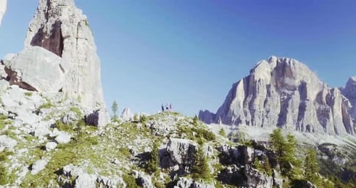 Aerial Flight Above People Hiking Along Trail Path in Sunny Day