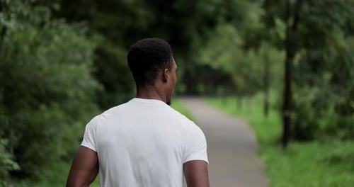 Back View of Man Running in Sportswear Outdoor