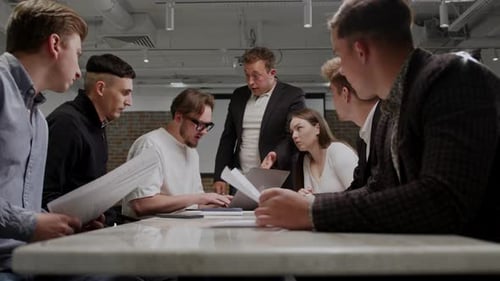 Team Reviewing Documents, Deadline Pressure in Modern Office