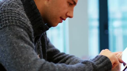 Young Adult Uses Tablet Device in Urban Setting