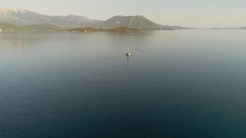 Aerial view of a sailboat driving in the mediterranean sea, Greece.