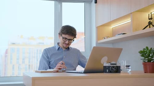 Adult working on a laptop at his desk