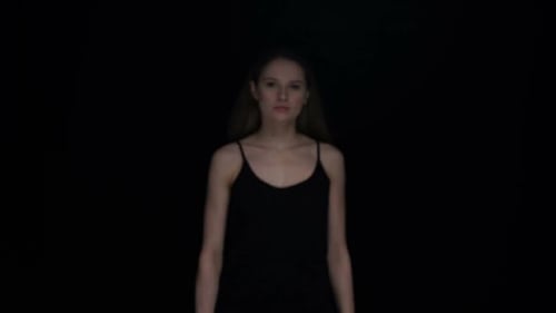 Woman Holding Sign in Dark Studio