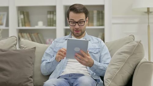 Man Chatting on Tablet During Video Conference Call