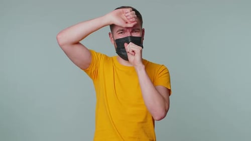 Man in Mask Coughing, Rubbing Throat