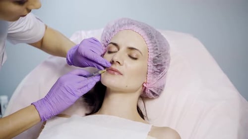 Woman Receiving Lip Filler Injections in Medical Office