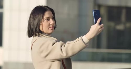 Portrait of Brunette Caucasian Businesswoman Having Video Call Outdoors