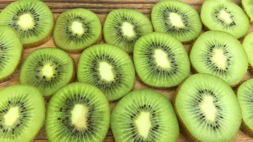 Fresh Kiwi Fruit Slices on Wooden Background