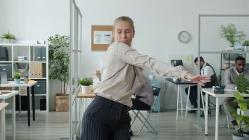 Slow Motion of Attractive Female Dancer Performing in Office While Businesspeople Working in