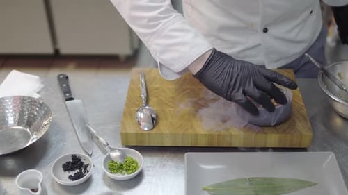 Chef in Black Rubber Gloves Finishing To Prepare Dish with Raw Tuna and Salmon in Modern Restaurant