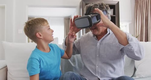 Boy Watches Man Using Virtual Reality Headset