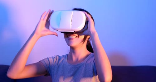 Woman Enjoys VR Headset Experience at Home