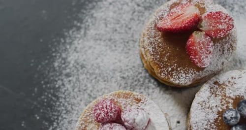 Video of pancakes on plate seen from above on wooden background