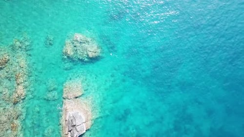 Aerial View of Turquoise wWaves Hitting Coral Reefs, Stones.