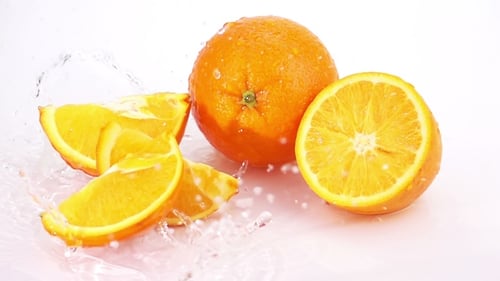 Slices of Orange are Falling on the Table