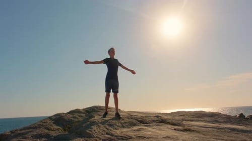 Young Adult Silhouette by the Ocean at Sunset