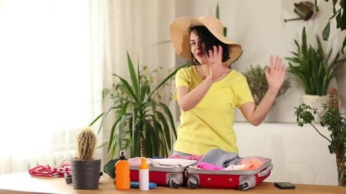 Woman Dancing Packing Suitcase for Vacation