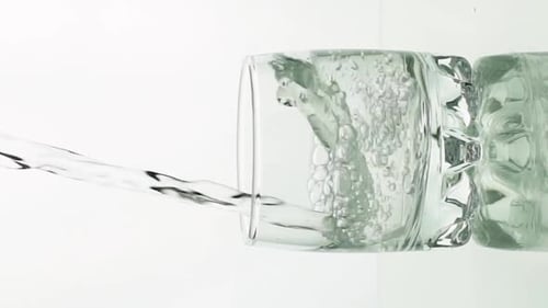 Water Pouring Into a Glass Cup Close Up