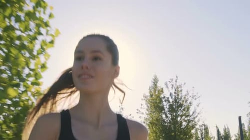 Sports Woman Makes Morning Jog and Physical Exercises In Park